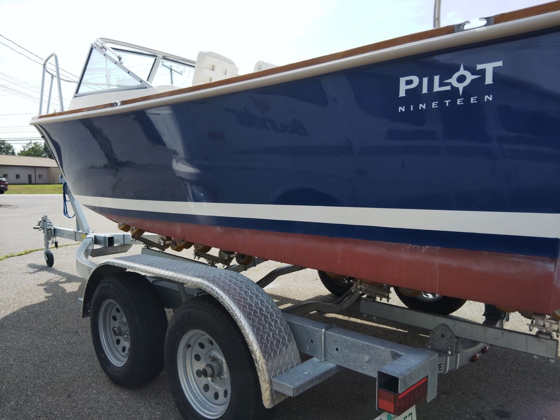 Pilot Nineteen boat after restoration — glossy, mirror-finish deep blue hull