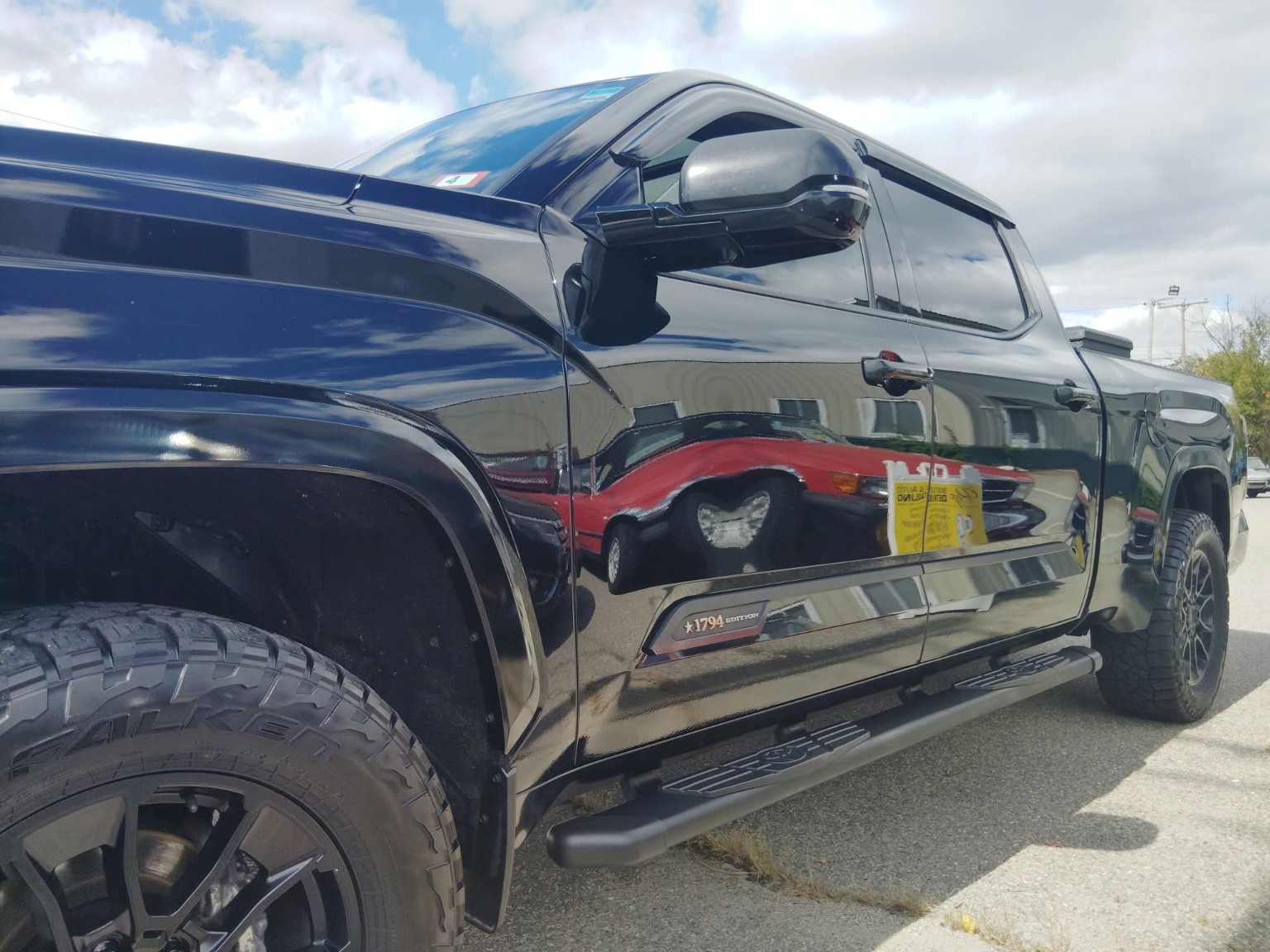 Mirror-finish paint reflection on a black Toyota detailed by Rye Boat & Auto Detailing
