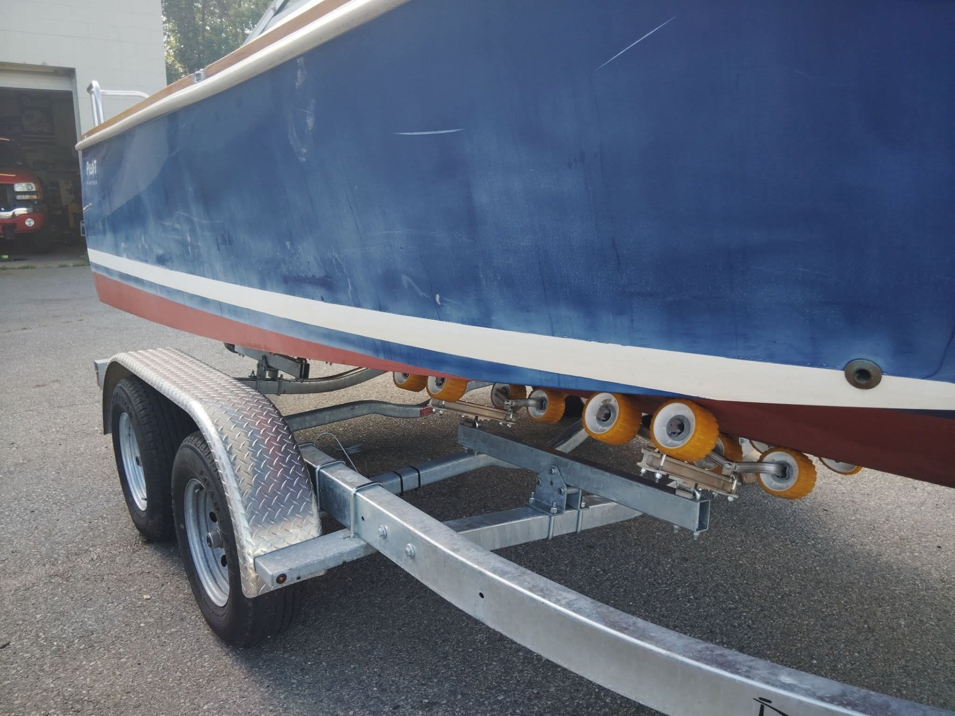 Pilot Nineteen boat before restoration — heavily oxidized, dull, and scratched deep blue hull