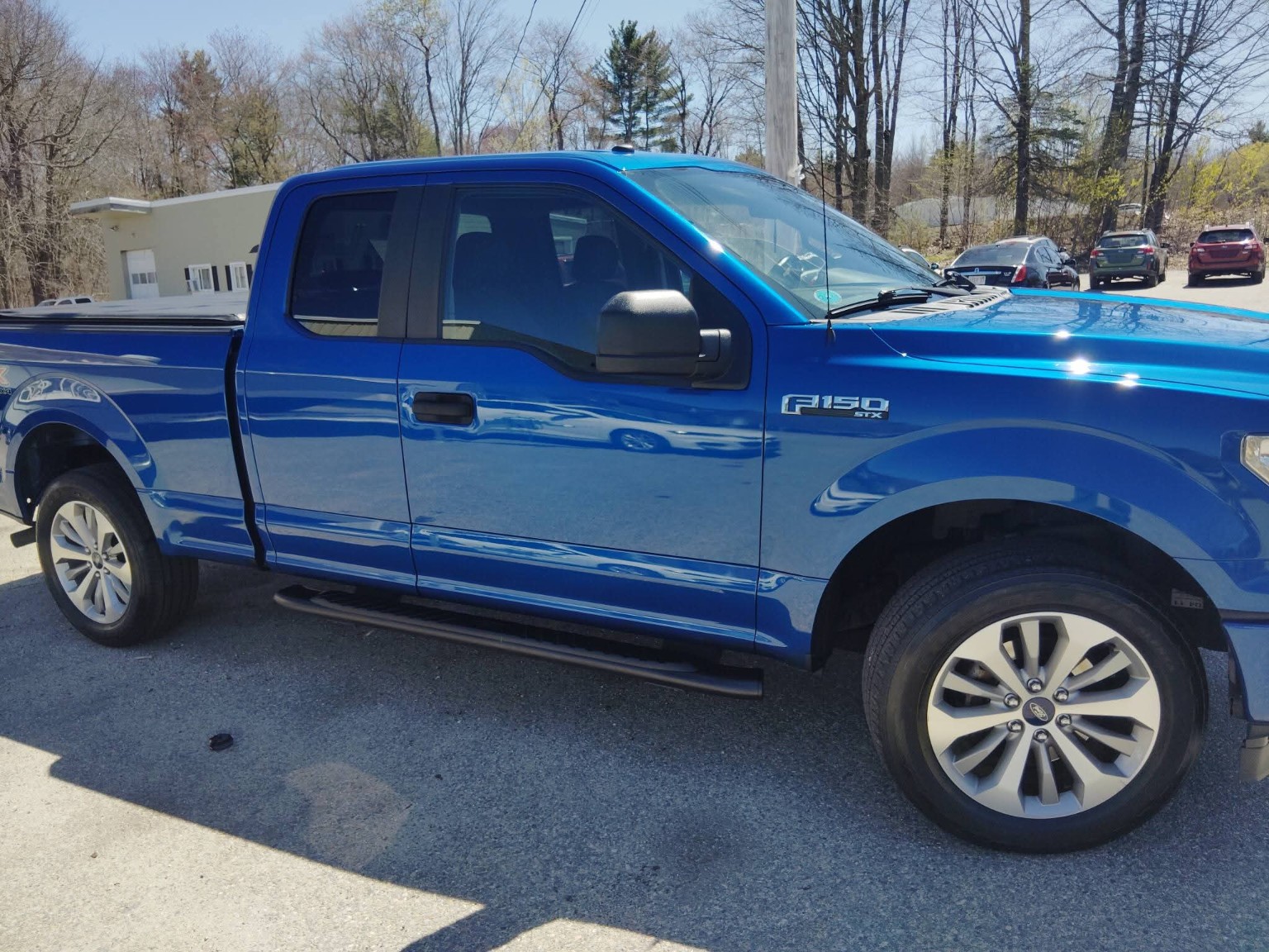Blue Ford F-150 pickup side profile after detailing